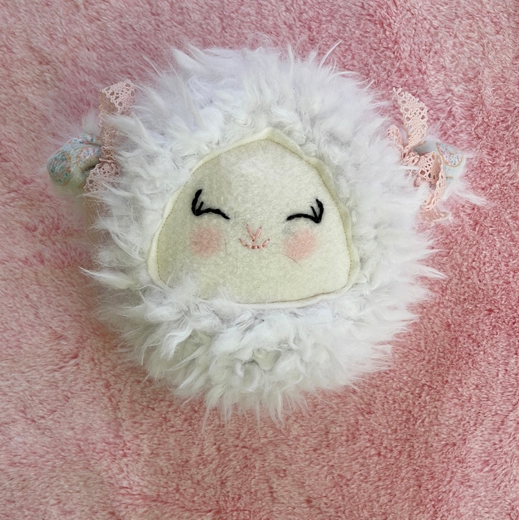 White lamb with pink bows